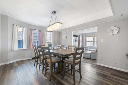 a dining room with a table and chairs at Escape to Raleigh Ave Glamour - Steps to the Beach in Atlantic City