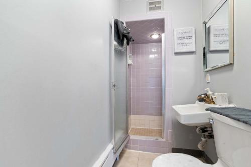 a bathroom with a shower and a sink at Escape to Raleigh Ave Glamour - Steps to the Beach in Atlantic City