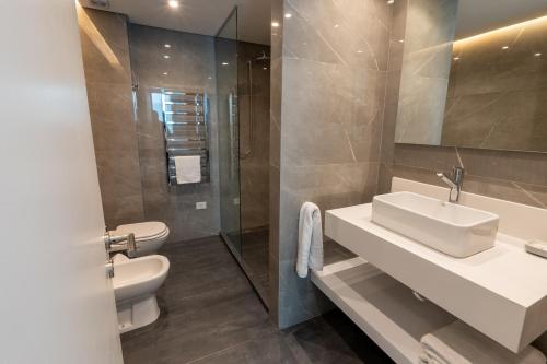 a bathroom with a sink and a toilet and a shower at Aparthotel Trianon Recoleta in Buenos Aires