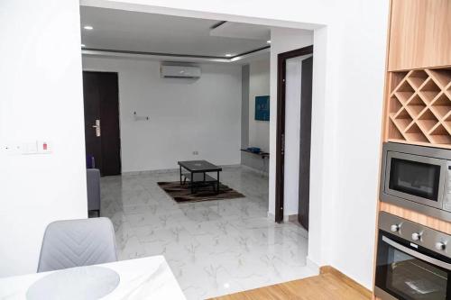 a living room with a table and a tv at HS Apartment and Duplex in Ogbojo