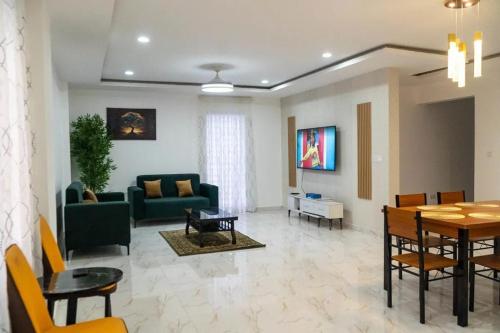 a living room with a couch and a table at HS Apartment and Duplex in Ogbojo