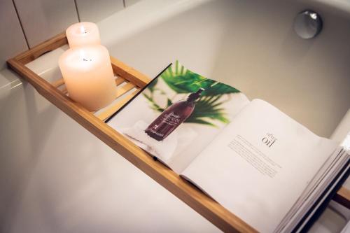 a shelf with a book and a candle and a candle at F I E R Huisje in Eersel
