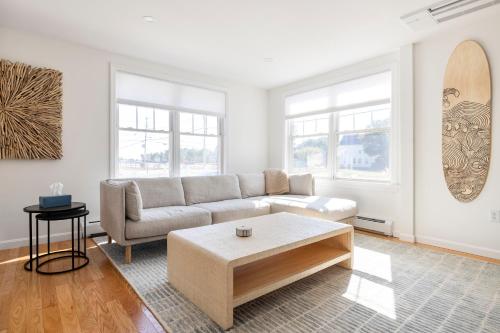 a living room with a couch and a coffee table at Sunny 3BR Beach House, Steps to Pine Point Beach in Scarborough