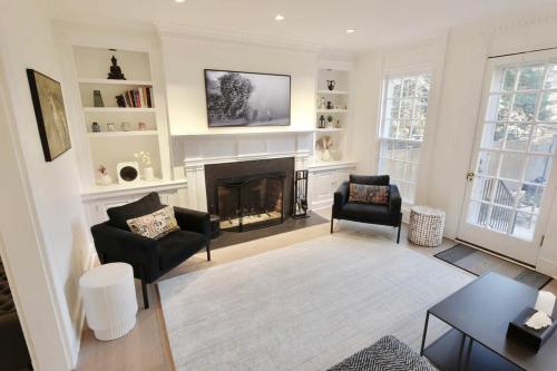 a living room with a fireplace and a tv at Idyllic Georgetown in Washington