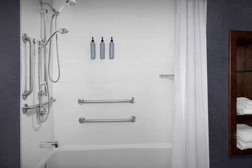 a bathroom with a shower and a shower curtain at Residence Inn by Marriott Fort Lauderdale Airport & Cruise Port in Dania Beach