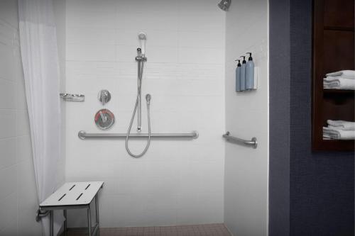 a shower stall in a bathroom with a bench at Residence Inn by Marriott Fort Lauderdale Airport & Cruise Port in Dania Beach
