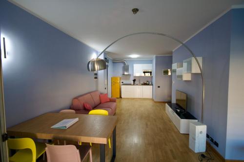 a living room with a table and a couch at H2ome - Il Cembalo vista baia e città balcone o terrazzo parcheggio su richiesta in Genova