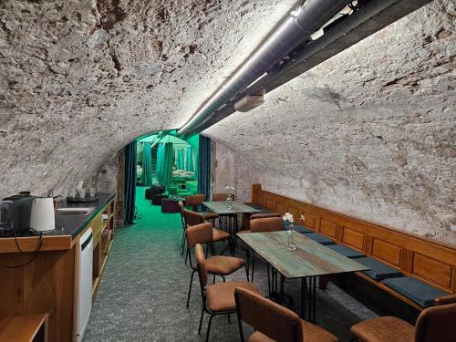 a restaurant with tables and chairs in a brick wall at Overnachten aan de Werf in Utrecht