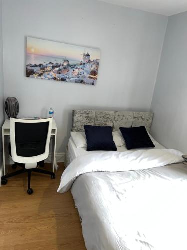 a bedroom with a bed and a desk with a computer at En-suite Room Near City Center 4 in Doncaster