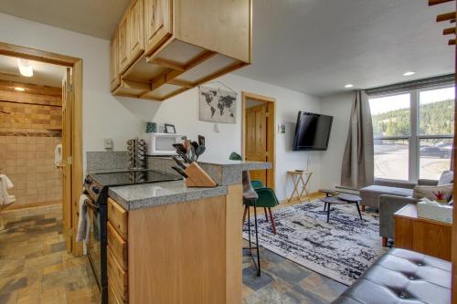 a kitchen with a counter top and a living room at Modern Mountain-View Condo at Big Sky Resort! in Big Sky