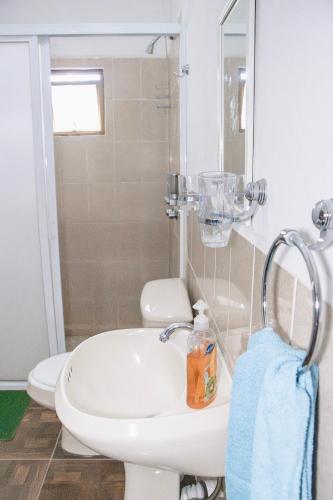 a bathroom with a white sink and a toilet at CORAZÓN DE TEPOZ in Tepoztlán
