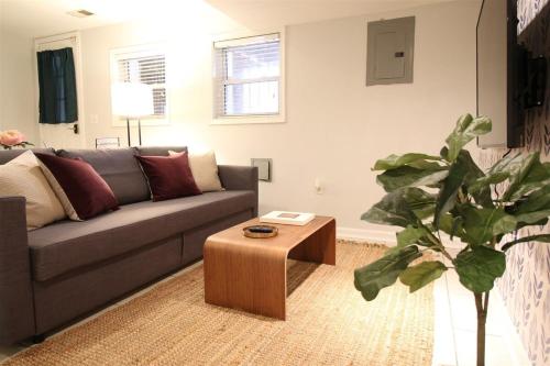 a living room with a couch and a coffee table at Lincoln Park Place Capitol Hill with Parking in Washington, D.C.