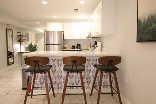 a kitchen with a counter and two bar stools at Lincoln Park Place Capitol Hill with Parking in Washington, D.C.
