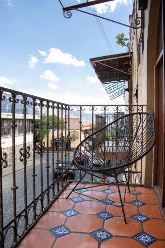 a chair on a balcony with a view of the ocean at CORAZÓN DE TEPOZ in Tepoztlán
