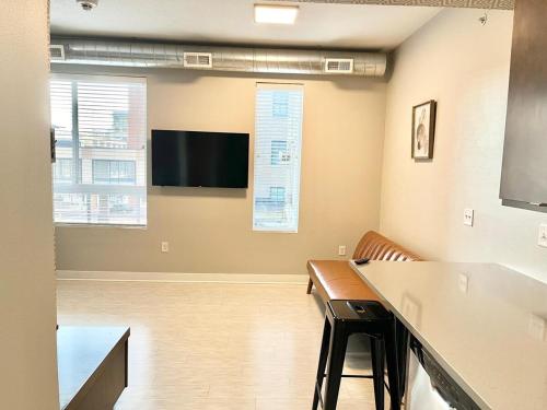 ein Besprechungsraum mit einem Flachbildfernseher an der Wand in der Unterkunft Urban Oasis Downtown Condo with Skywalk Access 6 in Des Moines