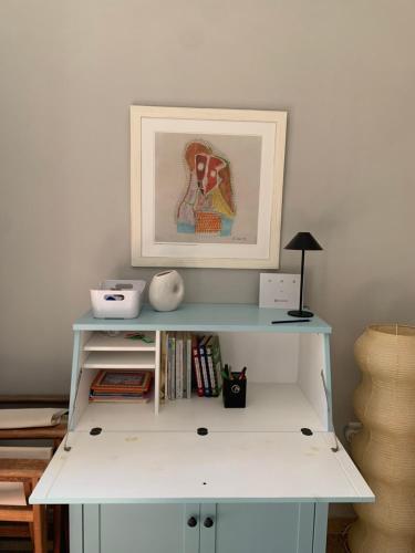 a white shelf with a picture on top of it at Nerinalia Residence in Áyioi Apóstoloi