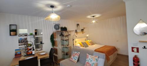 a bedroom with a bed and a desk in it at Cozy Studio - Chalé Seixal in Seixal