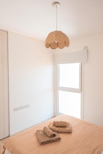 two towels on a table in a room with a window at Departamento Rivadavia Centro in Santa Rosa