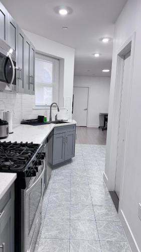 a kitchen with a stove and a counter top at Beautiful Bedroom with Attached Bathroom, 15 minutes from NYC in West New York