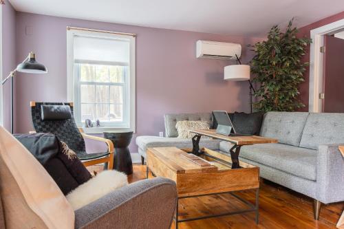a living room with a couch and a table at Chic Farmhouse Woodstock Saugerties Skiing HITS in Saugerties