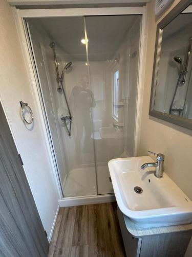 a bathroom with a shower and a sink at 34 Brean Leisure Park Unity Beach 6 berth Passes optional No pets in Brean