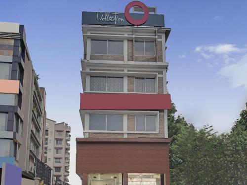 a tall building with a sign on top of it at Collection O Palm Tree Lodge in Siliguri