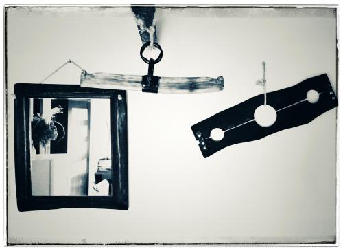 a mirror and a cross hanging on a wall at Cinderella Guitars in Czartoria