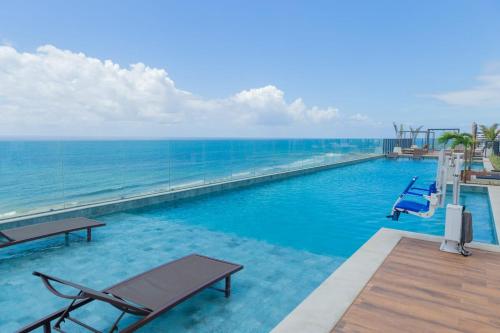 a swimming pool with a view of the ocean at ArtStudio Open Spaces in Salvador