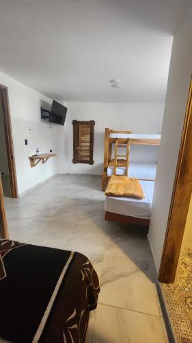 a room with two bunk beds and a tv at Hotel Boutique Ancestral in Sevilla