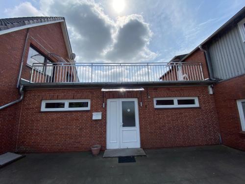 a brick building with a balcony on top of it at Garis Pension in Wesseln in Wesseln
