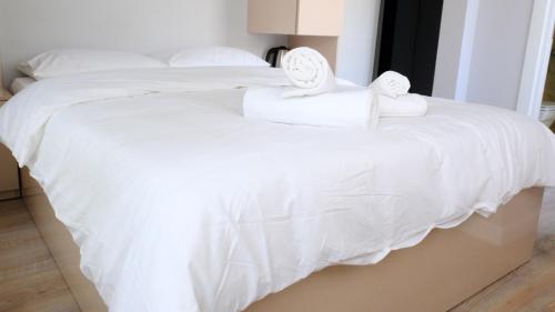 two beds with white sheets and towels on them at Rodax Residence in Istanbul