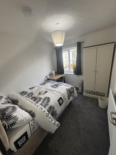 a bedroom with two beds with pillows on it at Cosy Charming room in big house in Little Hulton