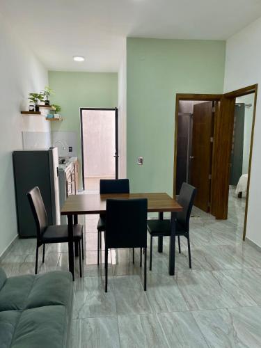 a dining room with a wooden table and chairs at Casa Madera - Departamento 3 in Tequila