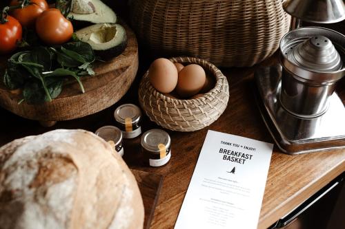 a table with baskets of bread and eggs on it at Kangaroo Ridge Retreat in Healesville