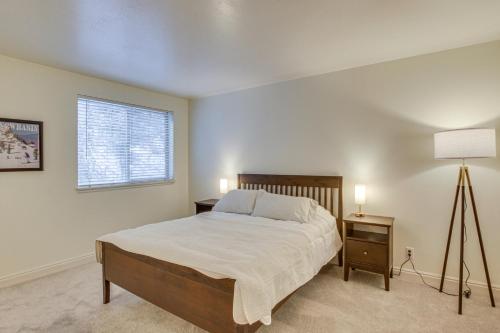 a bedroom with a bed and a lamp and a window at Ski, Kayak, Fish Ogden RioVista with Patio in Ogden