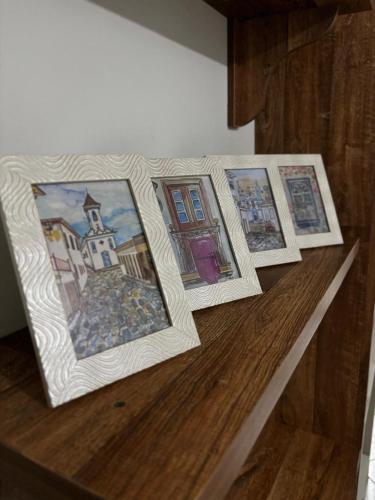 a group of four pictures sitting on top of a table at Centro Histórico Diamantina in Diamantina
