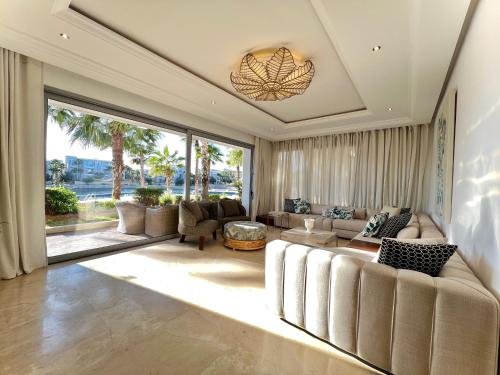 a living room with a couch and a large window at Ritz carlton luxurious stay in Marina Smir