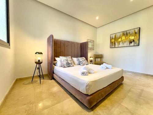 a bedroom with a large bed in a room at Ritz carlton luxurious stay in Marina Smir