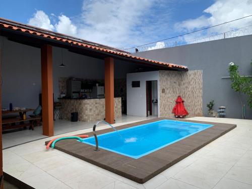 a swimming pool on the patio of a house at casa sol e mar 01 in Paripueira