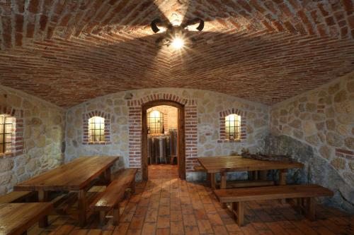 a room with wooden tables and a ceiling fan at Holiday home in Otocec - Kranjska (Krain) 33898 in Otočec
