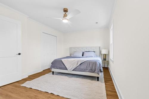 a white bedroom with a bed and a white rug at Modern 4 Bed in Quail Hollow in Charlotte