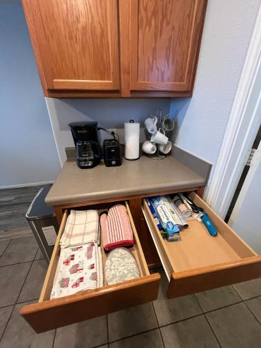 a kitchen counter with two drawers with ties on it at New Home with King Bed and 3 Bedrooms Fire-pit Minutes to Cota and Tesla in Austin