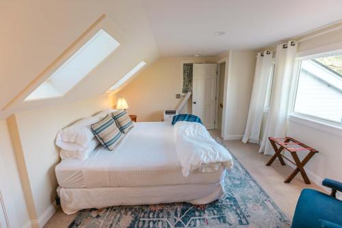 a bedroom with a bed in a room with windows at Hill Farm Inn - Manchester in Sunderland