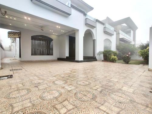 a large room with a tiled floor in front of a building at Luxury Villa - 1 Kanal Furnished 5 bedrooms , DHA Phase 6 in Lahore