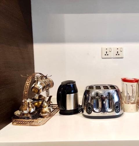 a counter top with a toaster and other items on it at Luxury Villa - 1 Kanal Furnished 5 bedrooms , DHA Phase 6 in Lahore