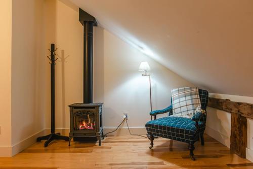a living room with a chair and a fireplace at Hill Farm Inn - Manchester in Sunderland