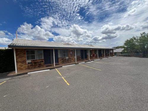 a building with a parking lot in front of it at Almond Inn Motel in Tamworth