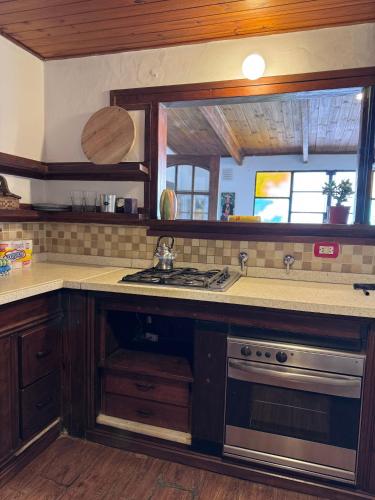 a kitchen with a sink and a stove at La Casa de Ignacia in Estación Ramallo