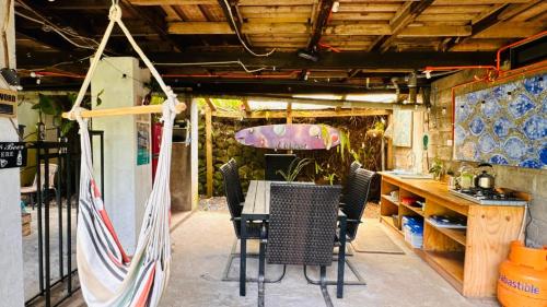 a dining room with a table and chairs at Mata Nui Eco hostel in Hanga Roa