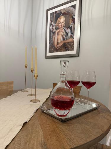 a table with two glasses of red wine on a tray at BAYCROFT House in London